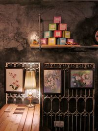 Multi colored candles on table against wall