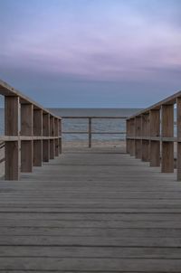 Wooden pier on sea against sky