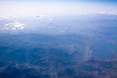 Aerial view of mountain range against sky