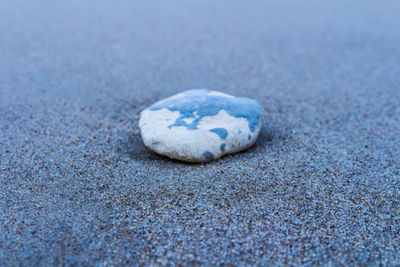 Close-up of pebbles on sand