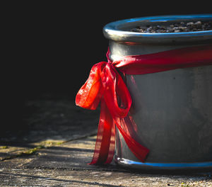 Close-up of red container against black background