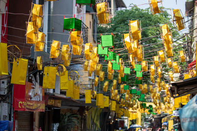 Low angle view of illuminated street amidst buildings in city