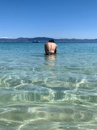 Portrait of man in sea against clear sky