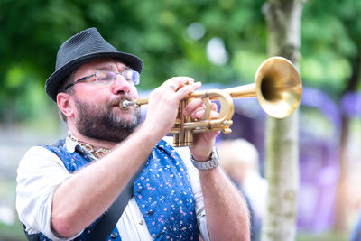 Man playing trumpet outdoors