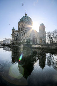 Reflection of cathedral in water against sky