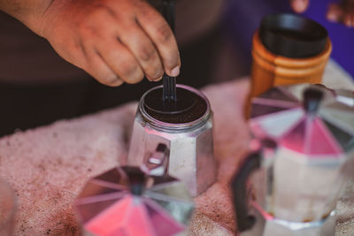 Close-up of hand holding glass of jar