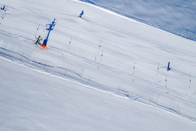 High angle view of people skiing on snowcapped mountain