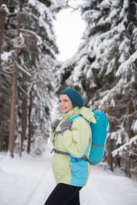 Full length of woman standing on snow covered land