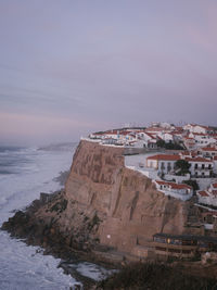 High angle view of townscape by sea against sky