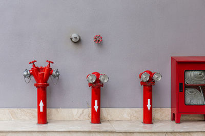 Red fire hydrant on wall