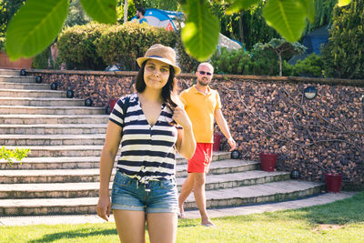 Portrait of couple against steps at park