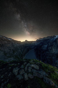 Scenic view of snowcapped mountains against sky at night