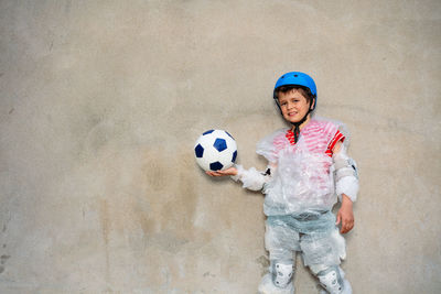 Portrait of boy playing soccer ball