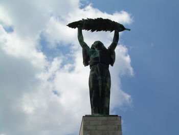 Low angle view of statue against cloudy sky