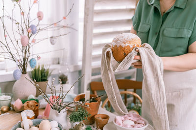 Happy easter holiday time in spring season. young housewife woman holds a freshly baked pastry cake