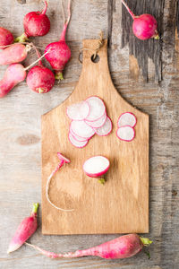 Fresh sliced radish on a cutting board on a wooden table. vegetables for a vegetarian diet