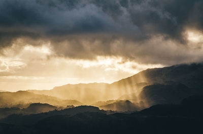 Scenic view of silhouette mountains against sky during sunset