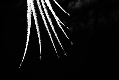 Low angle view of firework display at night