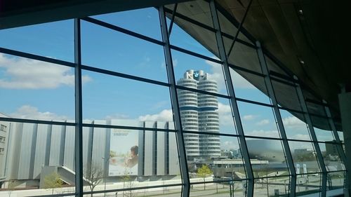 Low angle view of glass building against sky