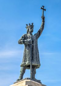 Low angle view of statue against blue sky