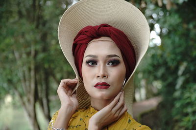 Portrait of young woman wearing hat