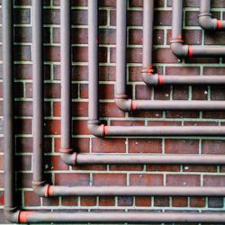 Full frame shot of pipes on brick wall