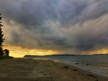 Scenic view of beach against sky during sunset