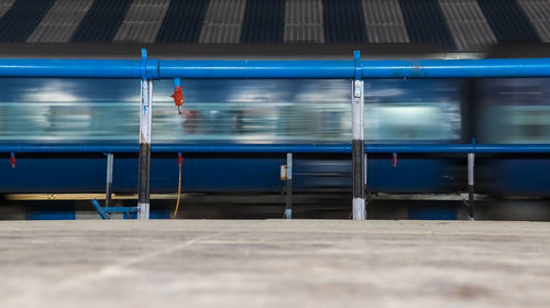 Blurred motion of train at railroad station