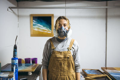 Portrait of female resin artist in homemade art studio