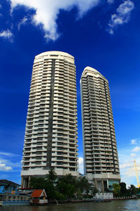 Low angle view of modern building against blue sky