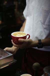Cropped hand of woman holding telephone
