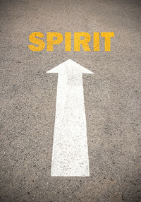 High angle view of arrow sign on road