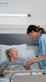 Side view of doctor examining patient at home