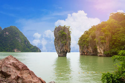 Scenic view of sea and mountains against sky