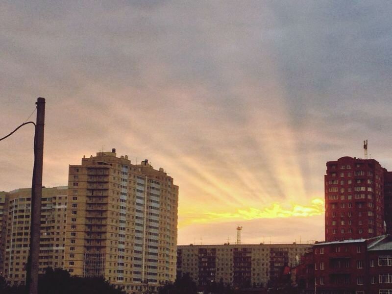 building exterior, architecture, sunset, built structure, city, sky, cloud - sky, orange color, cityscape, silhouette, skyscraper, residential building, low angle view, cloudy, cloud, building, residential structure, tall - high, tower, city life