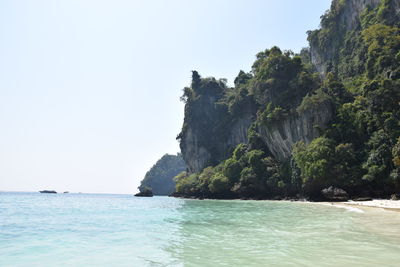 Scenic view of sea and rock formation against clear sky