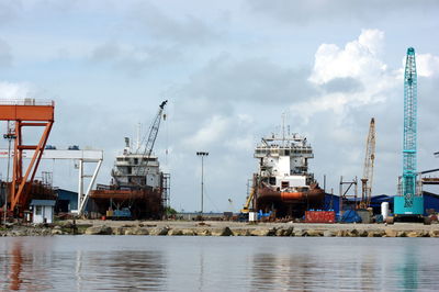 Harbor by sea against sky