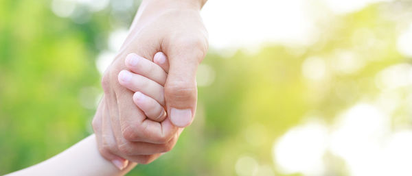 Cropped hand of woman holding hands