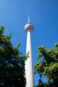 Low angle view of communications tower against sky