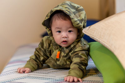 Portrait of cute baby girl sitting at home