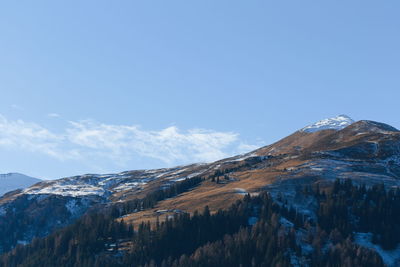 Scenic view of snowcapped mountains against blue sky