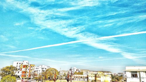 Low angle view of vapor trail against blue sky