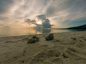 Scenic view of beach against sky during sunset