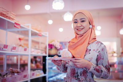 Young woman using smart phone at store