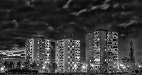 Low angle view of skyscrapers against sky at night