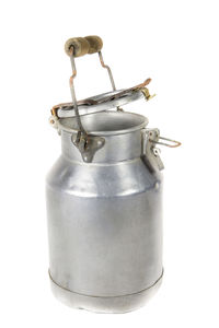 Close-up of metal container against white background