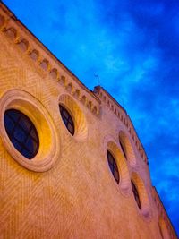 Low angle view of built structure against blue sky