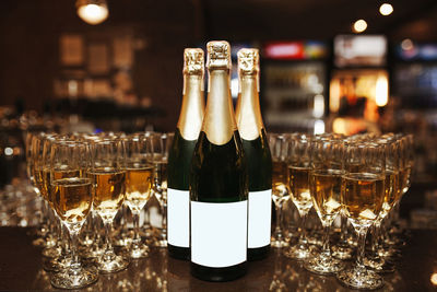 Glass of wine bottles on table