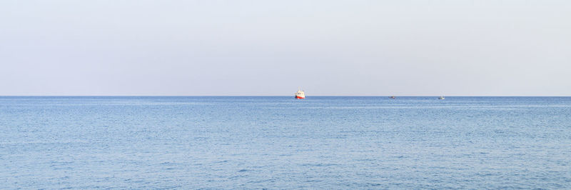 Sailboat in sea against clear sky