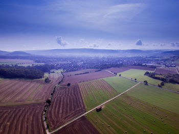 Aerial view of agricultural field against sky